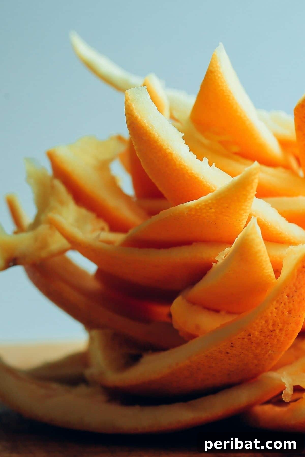 Stack of orange peels on a wooden surface