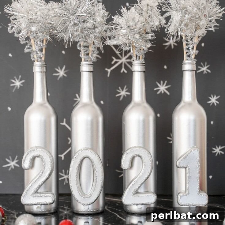 A silver painted wine bottle decoration with tinsel and numbers, set against a blurred background, ideal for New Year's Eve decor.