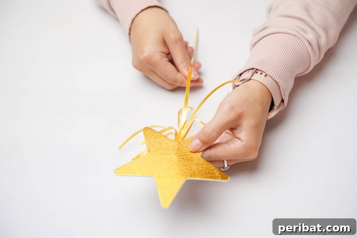 The delicate task of attaching a star and ribbon to a wooden dowel using hot glue.
