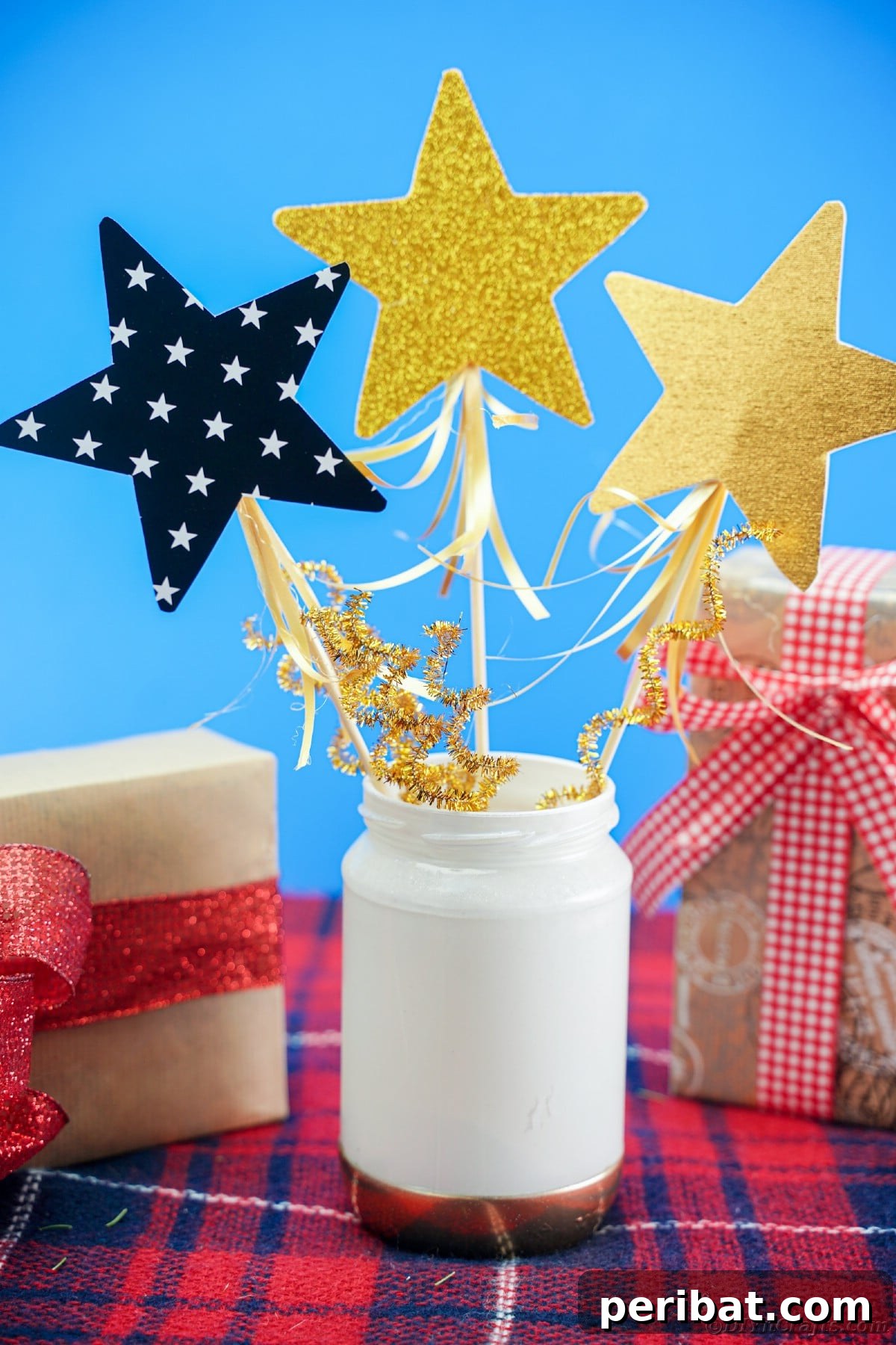 A vibrant mason jar centerpiece with gold and white accents, positioned against a striking blue background.