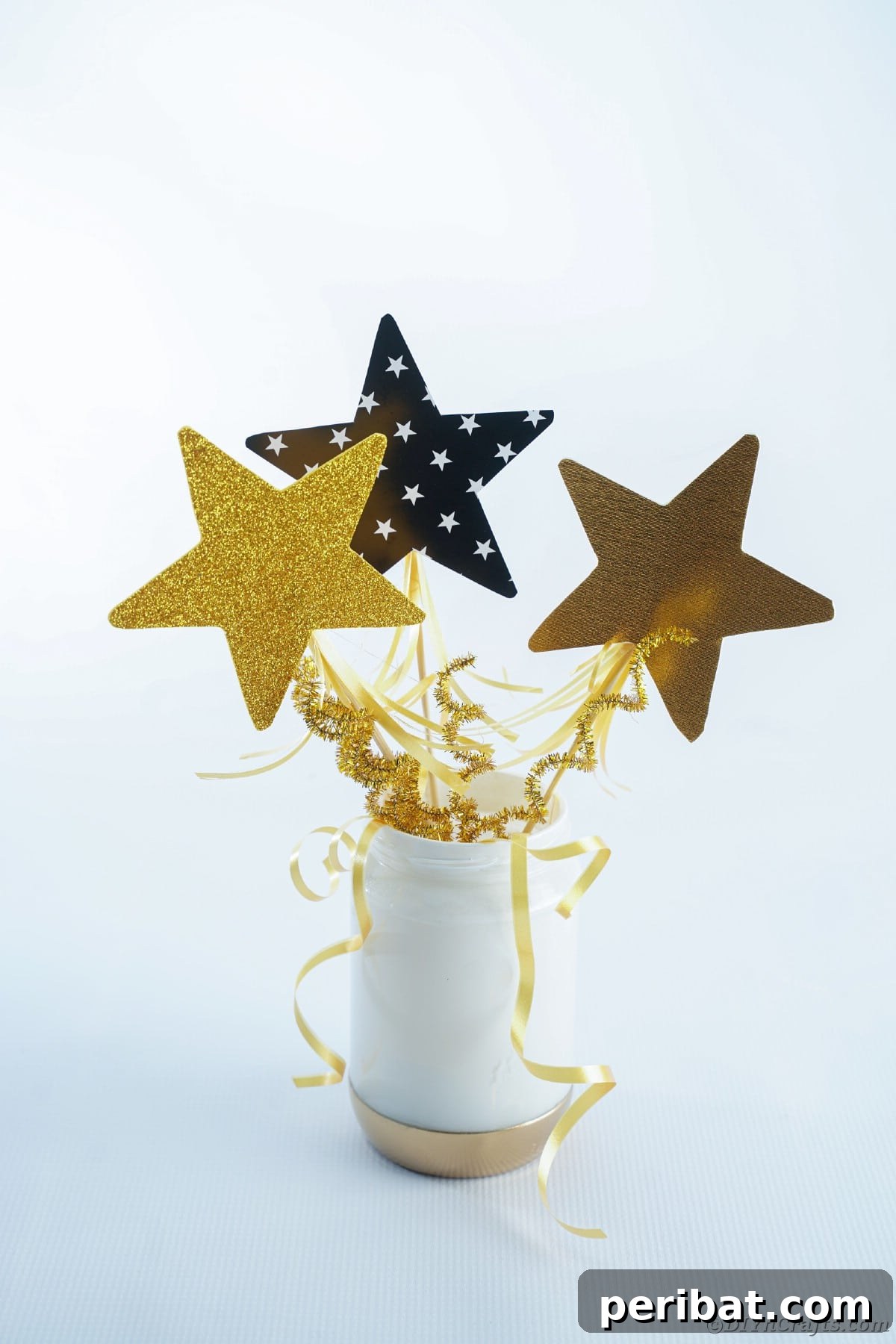 A meticulously crafted gold and white mason jar centerpiece, presented against a clean white wall, exuding sophisticated charm.