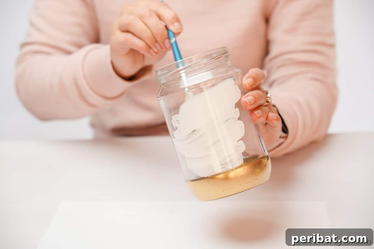 The technique of painting the inside of a mason jar white for a clean, vibrant finish.