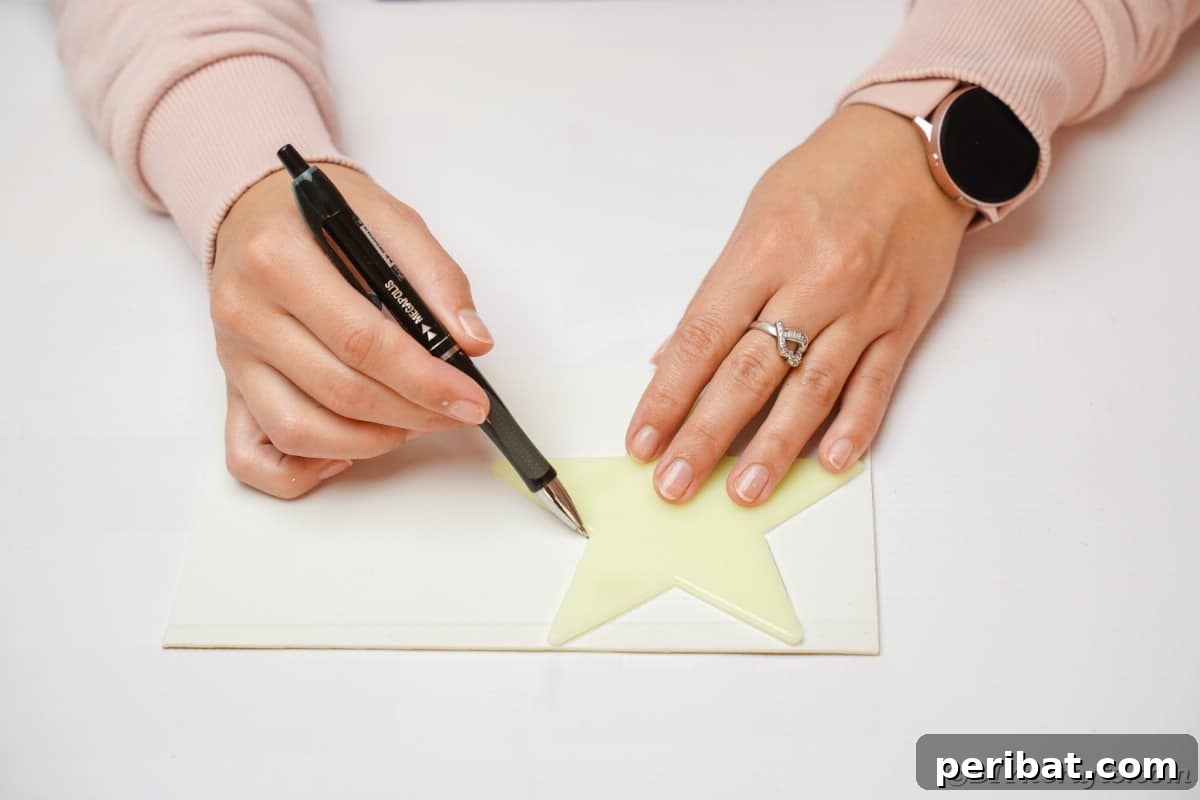A close-up view of tracing a star outline onto foam paper for decorative accents.
