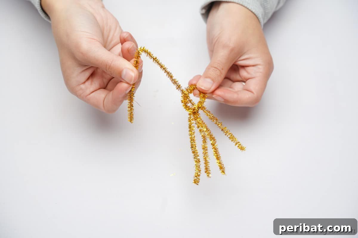 Twist Up a Dazzling Pipe Cleaner Fireworks Ring 11 Hands looping folded pipe cleaner halves around the top of the previously made ring base, creating an intertwining effect