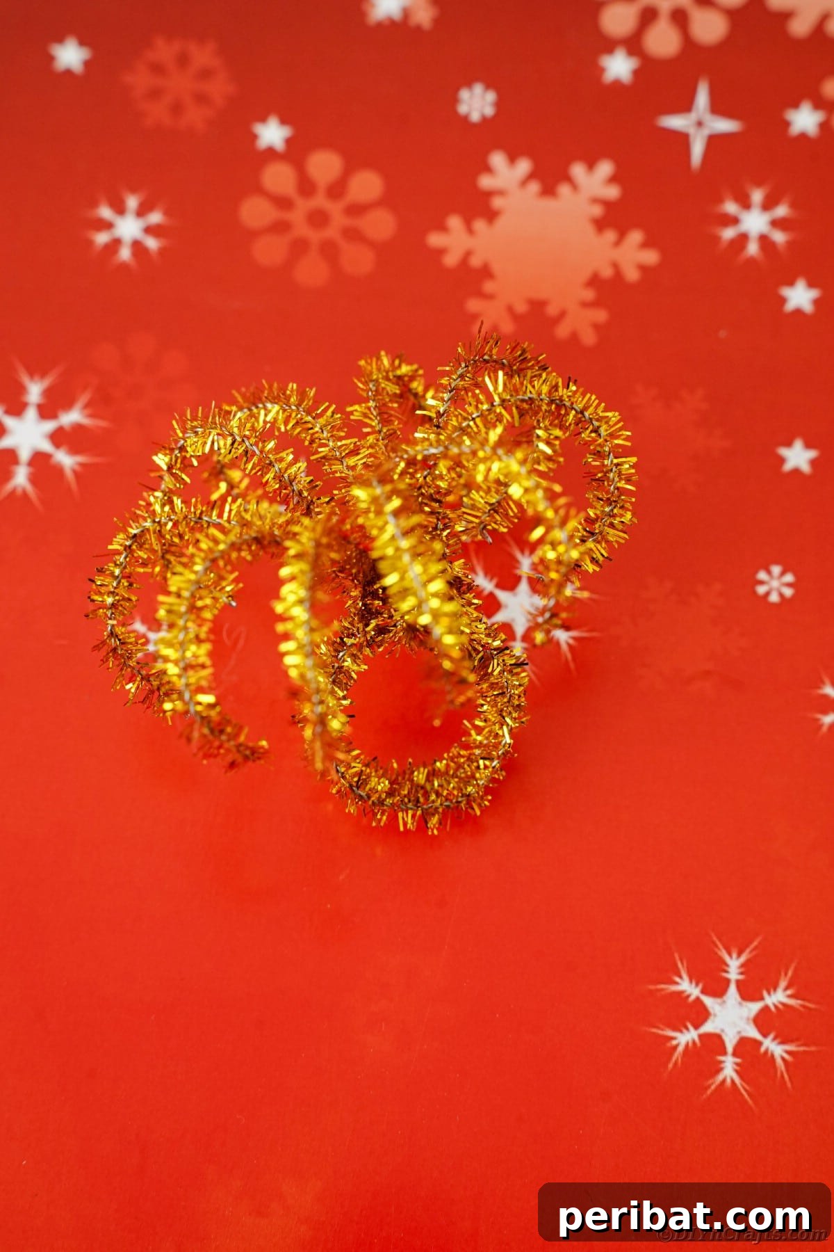 Twist Up a Dazzling Pipe Cleaner Fireworks Ring 14 A completed pipe cleaner fireworks ring resting on a vibrant red paper, ready for celebration
