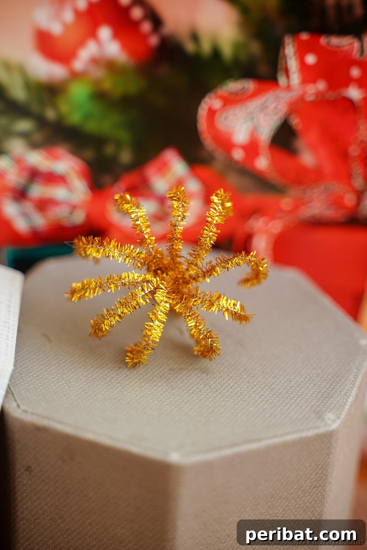 Twist Up a Dazzling Pipe Cleaner Fireworks Ring 15 A handmade fireworks ring made from pipe cleaners, creatively placed on a patterned box