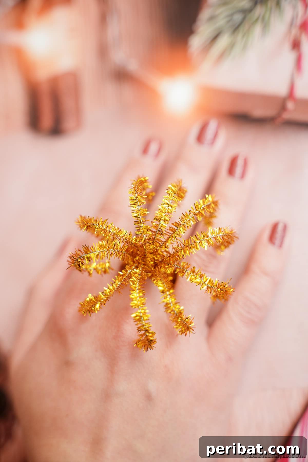 Twist Up a Dazzling Pipe Cleaner Fireworks Ring 16 A pipe cleaner ring designed to look like fireworks, elegantly worn on a woman's hand, sparkling in the light