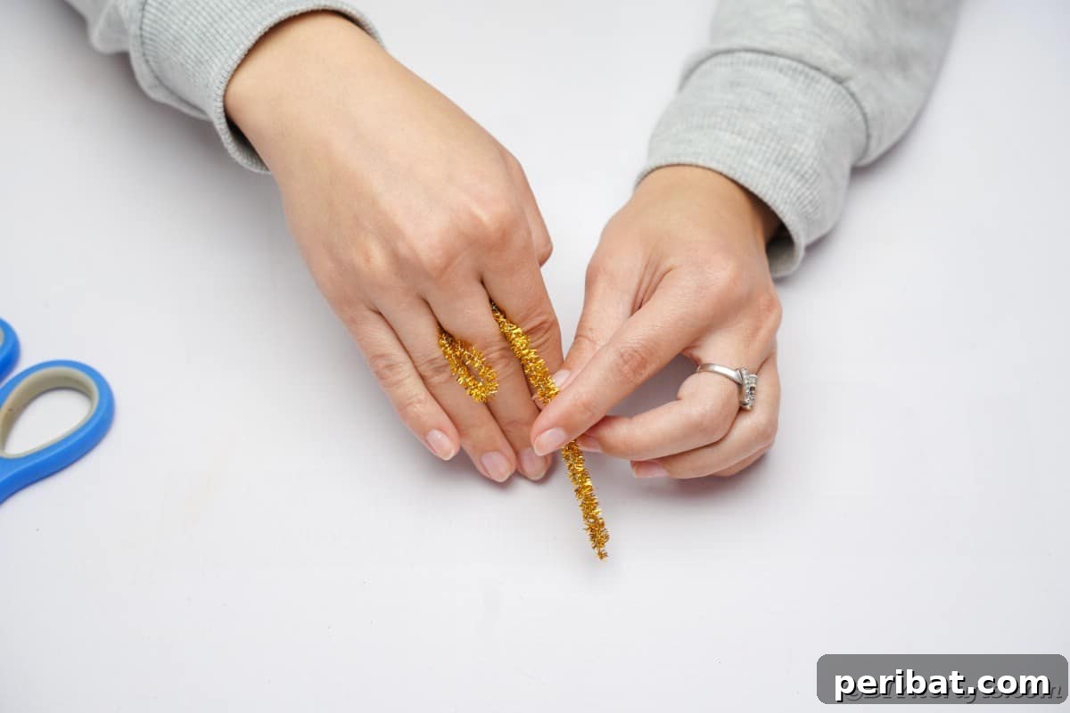 Twist Up a Dazzling Pipe Cleaner Fireworks Ring 8 Hands demonstrating the initial step of wrapping a folded pipe cleaner around a finger to form a ring base