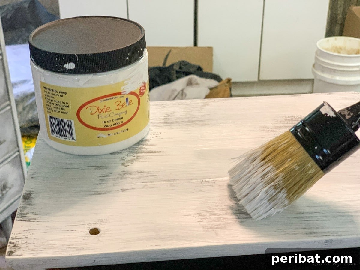 Painting the underside of the curio cabinet with the top coat