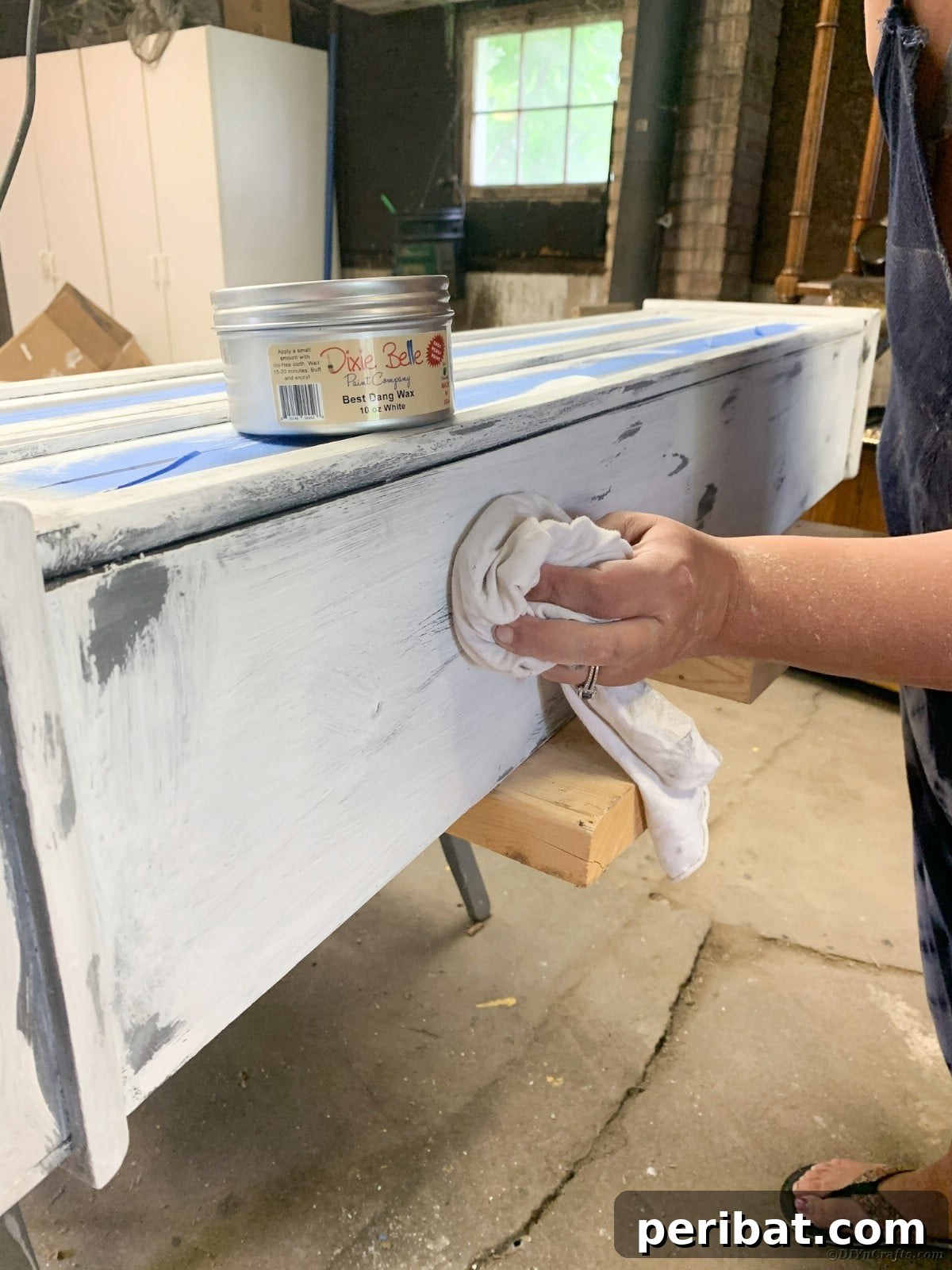 Applying grunge gray wax to areas of the curio cabinet