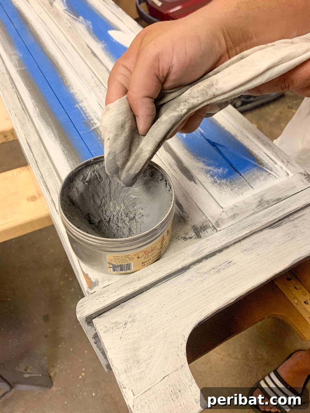 Detail shot of applying grunge gray wax to curio cabinet