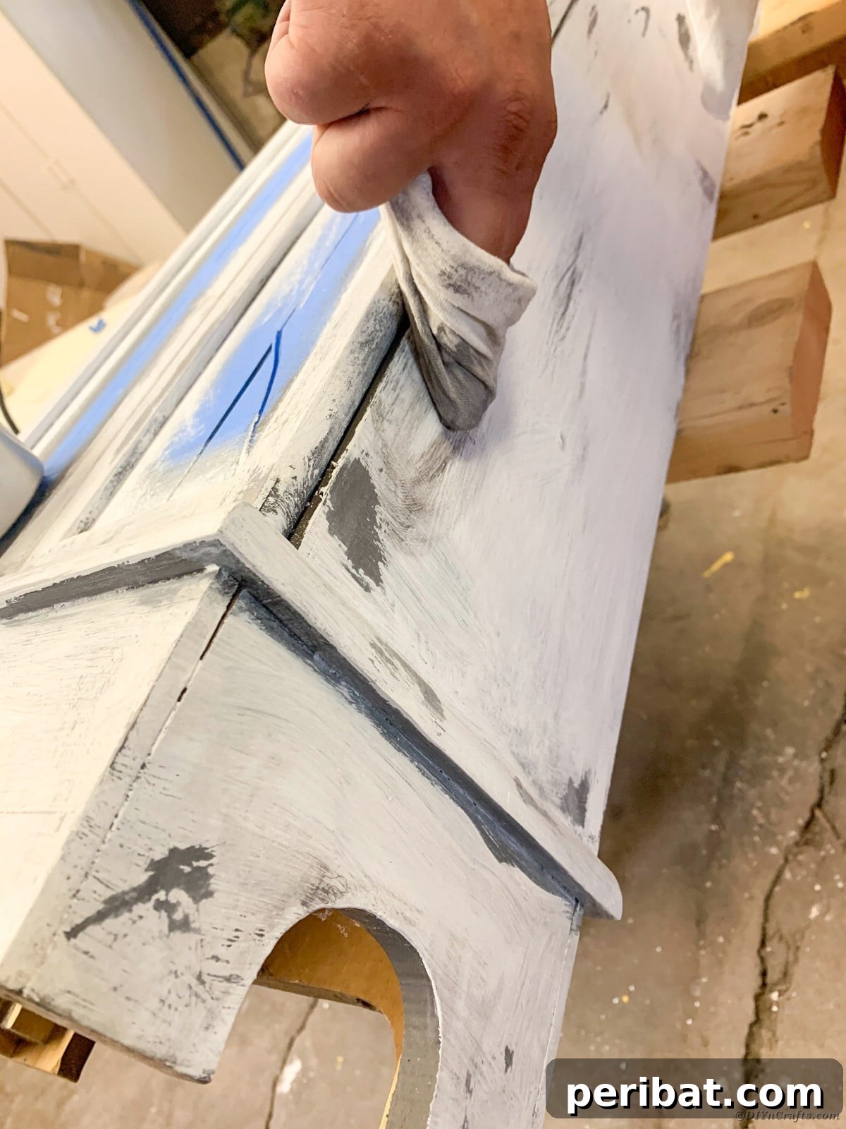 Buffing the grunge gray wax into the curio cabinet