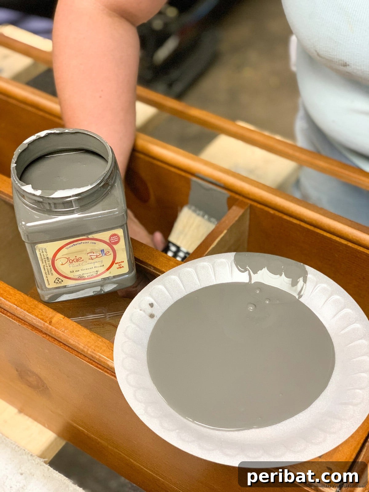 Applying the first coat of paint to the curio cabinet