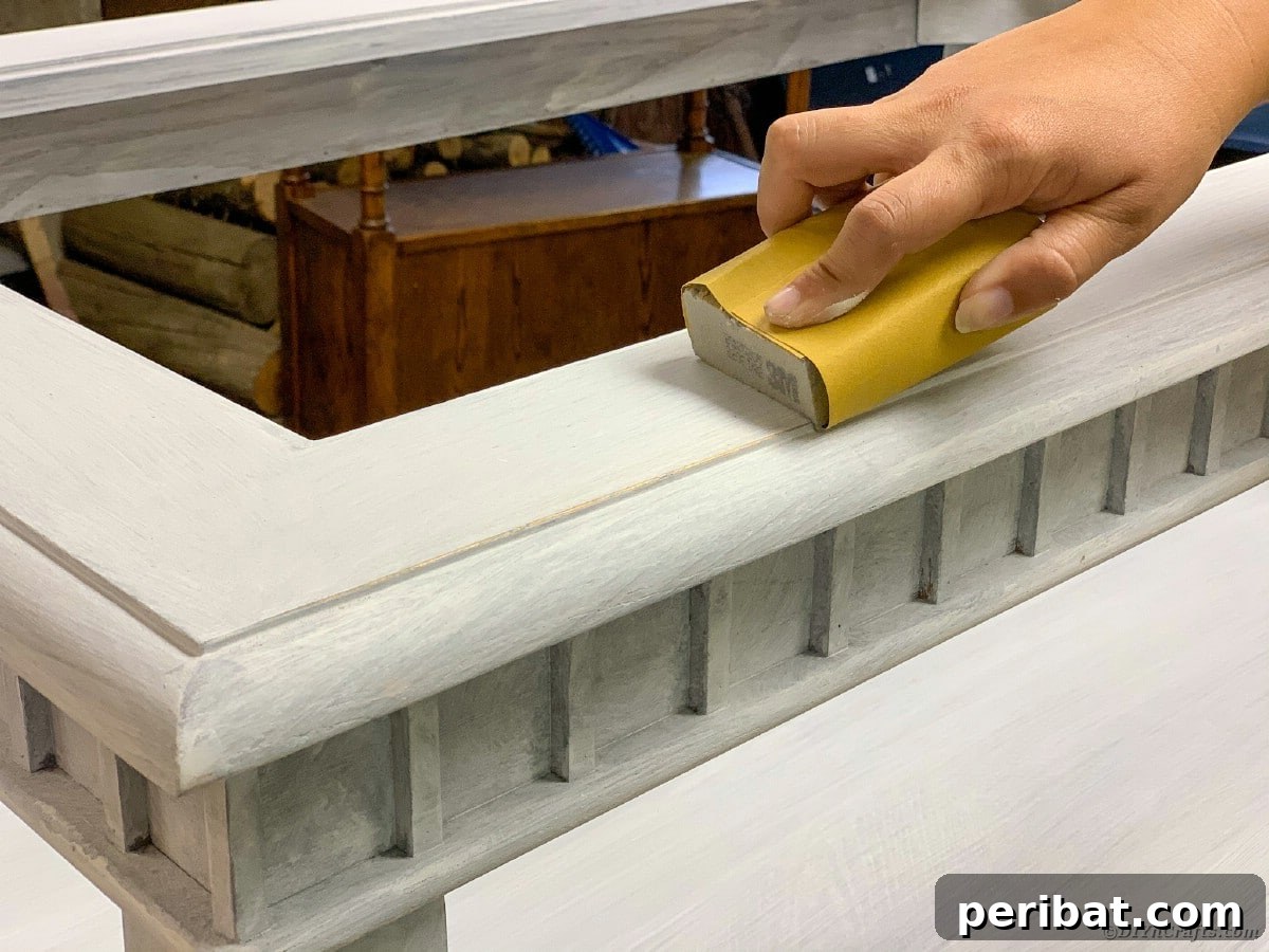 Lightly sanding a table for distressing