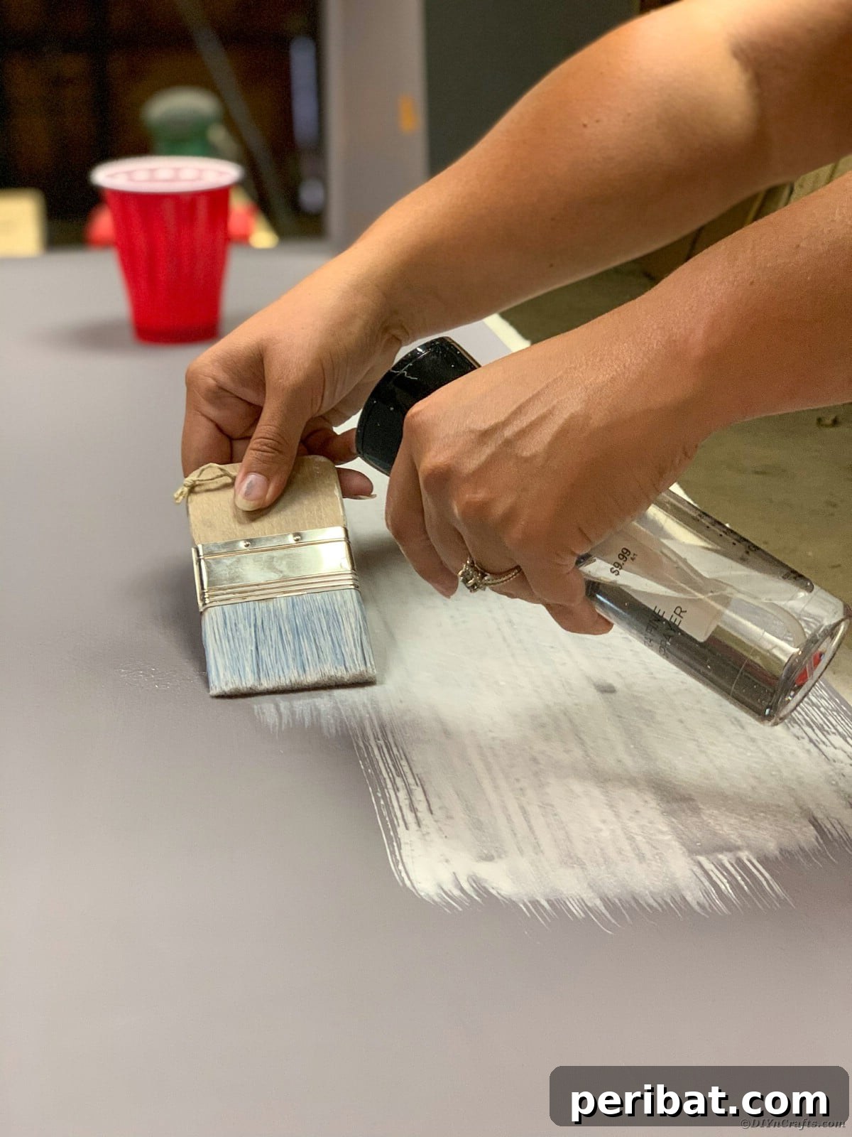 Artist painting the table surface