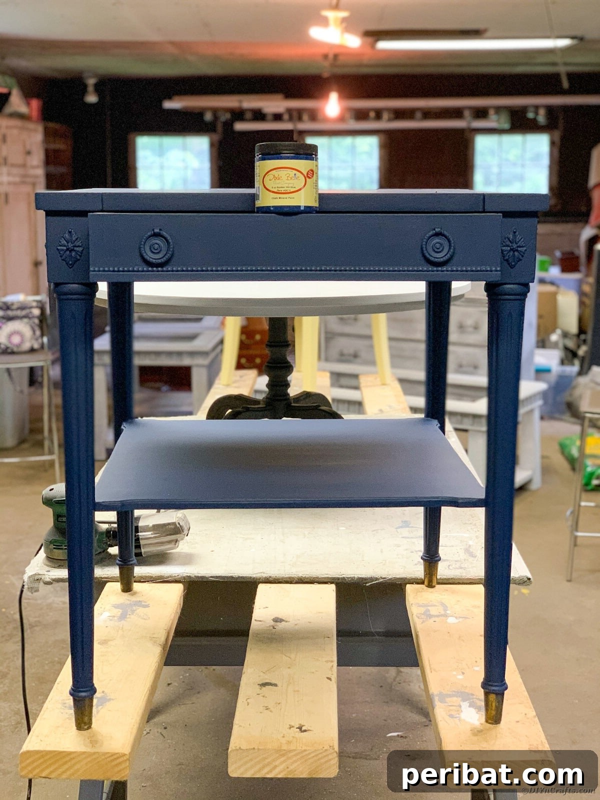 Side table with first coat of blue chalk paint applied, drying
