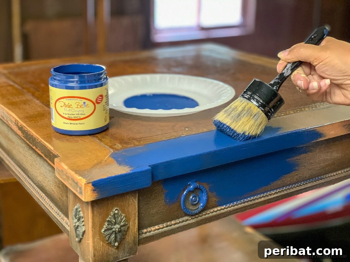 Applying the first coat of chalk paint to the side table