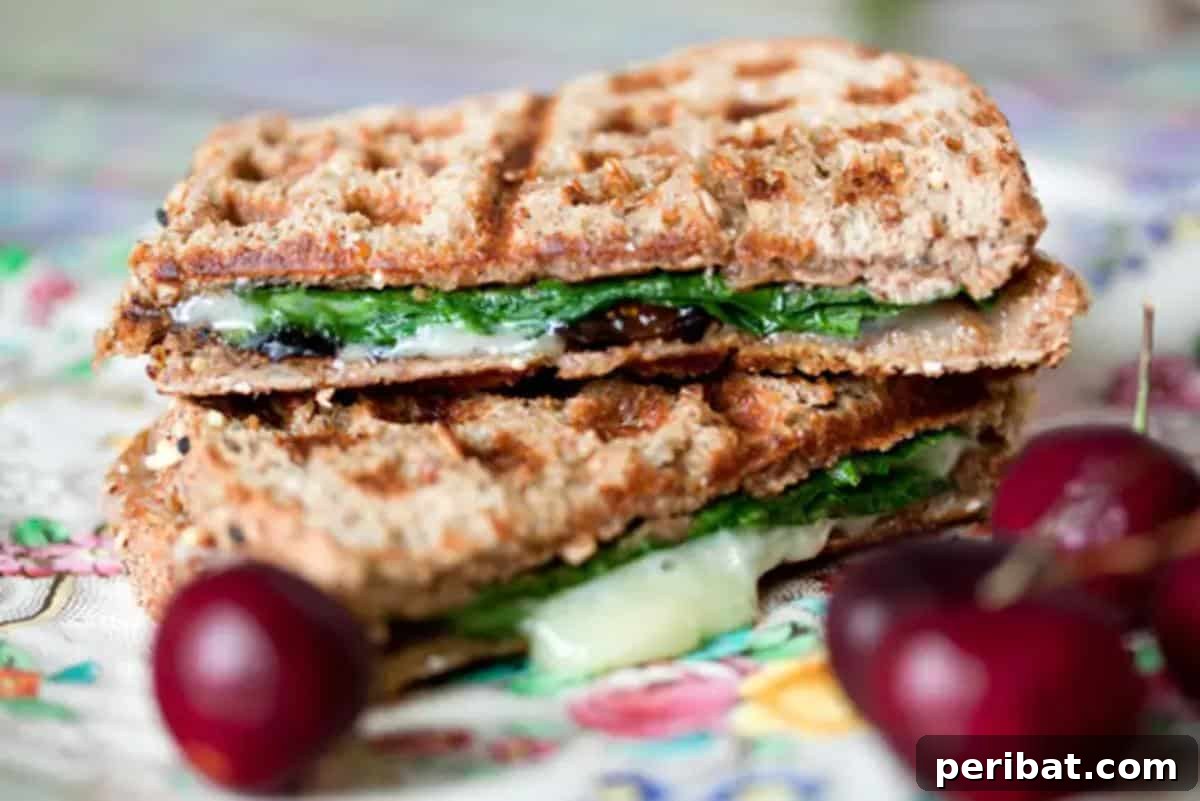 A gourmet Oregon Summer Panino, cooked in a waffle iron, revealing a delicious combination of ingredients with appealing grill marks.