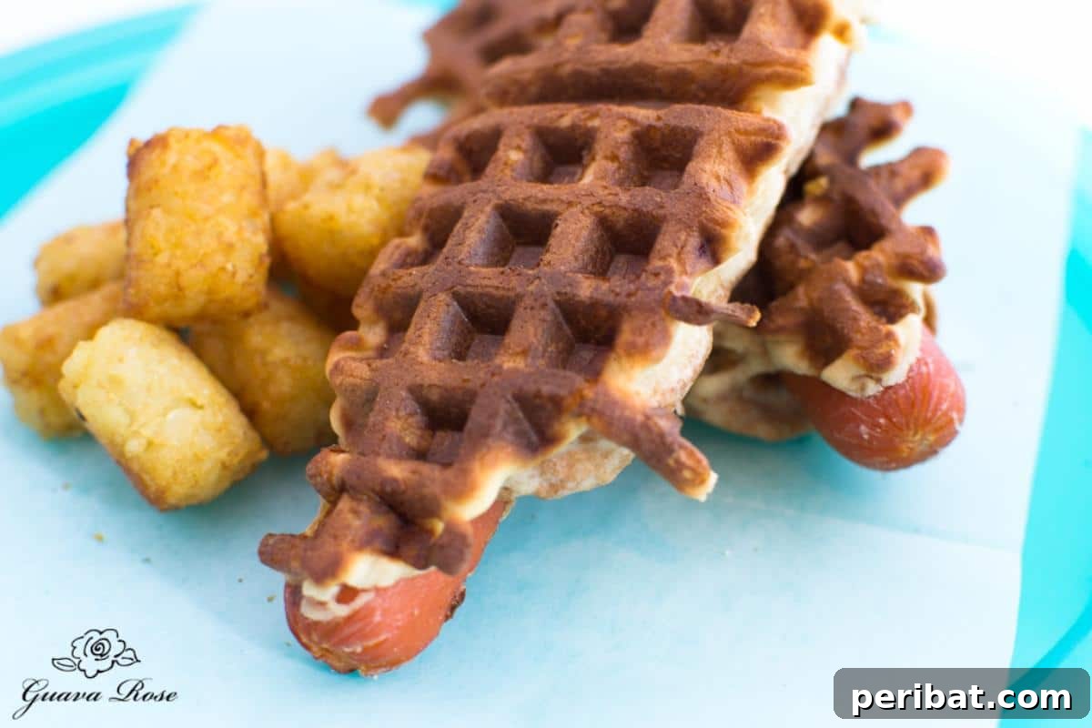 Mini hot dogs wrapped in bread and cooked in a waffle iron, creating a unique, crispy texture akin to corn dogs but with waffle patterns.
