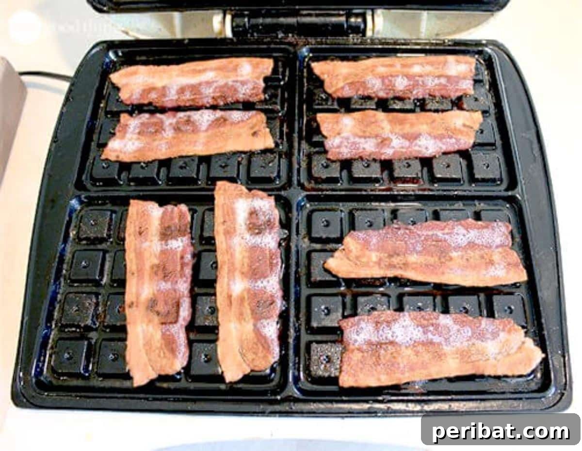 Crispy bacon strips cooked to perfection in a waffle iron, showcasing the unique texture created by the grids.