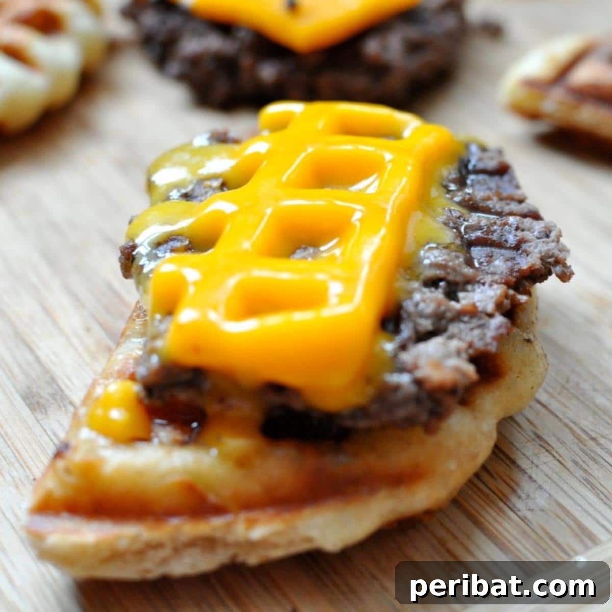 A unique waffleburger, featuring a beef patty cooked with waffle marks, topped with cheese and fresh vegetables on a bun.