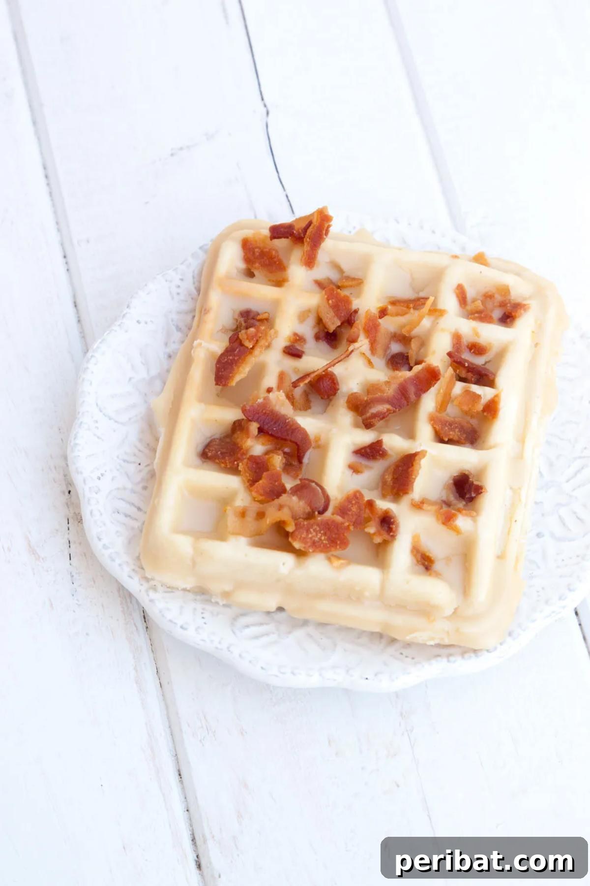 Gourmet maple bacon waffle donuts, generously covered in sweet maple glaze and savory crispy bacon bits, presenting a rich texture and flavor.