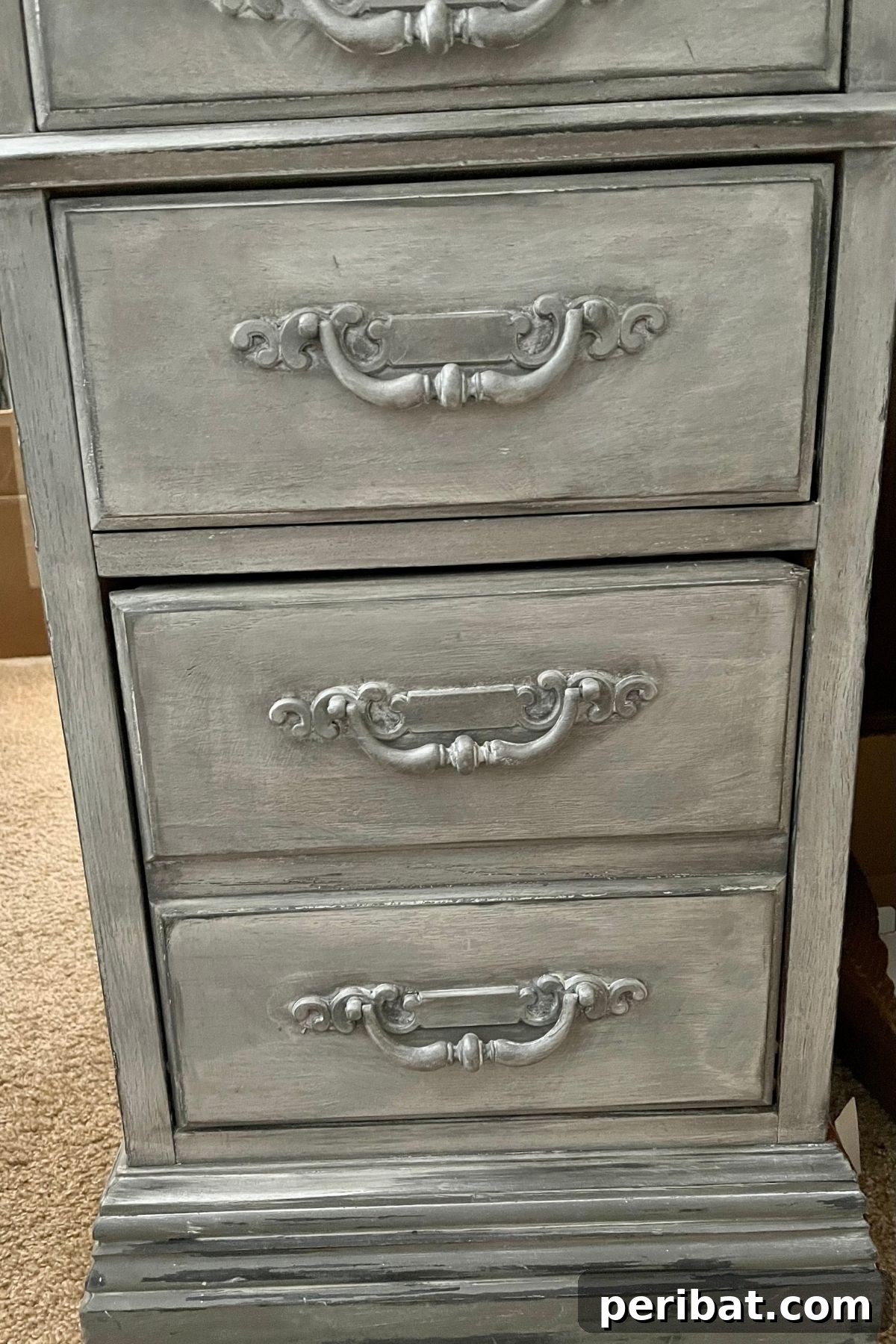 Close-up of the distressed drawers of the finished farmhouse desk, showcasing intricate details and textures.