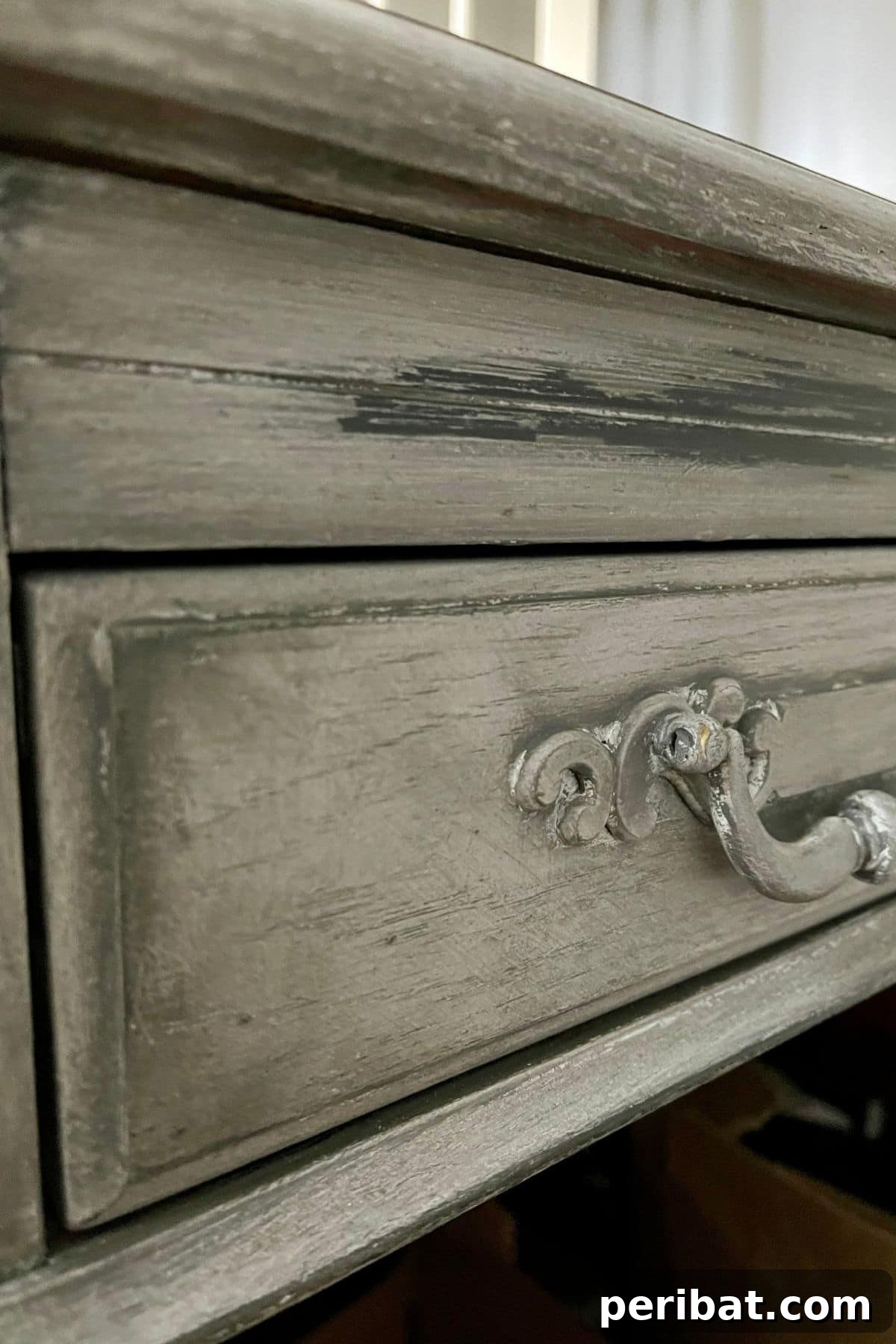 A drawer of the distressed desk, showing the detailed paint finish and hardware.