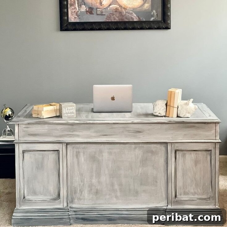 Beautifully distressed wood desk positioned against a wall, showcasing its completed modern farmhouse style.