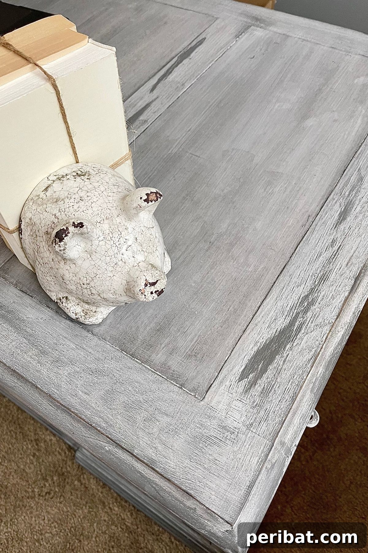 Close-up view of the top surface of a distressed wood desk, showcasing intricate details and weathered texture.