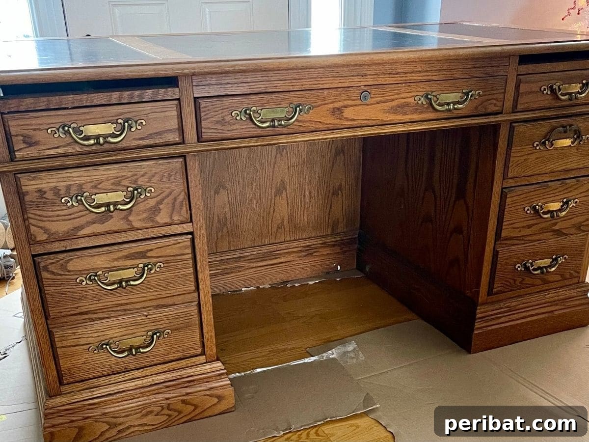 An old, unpainted wooden desk, ready for its transformation through distressing and painting.