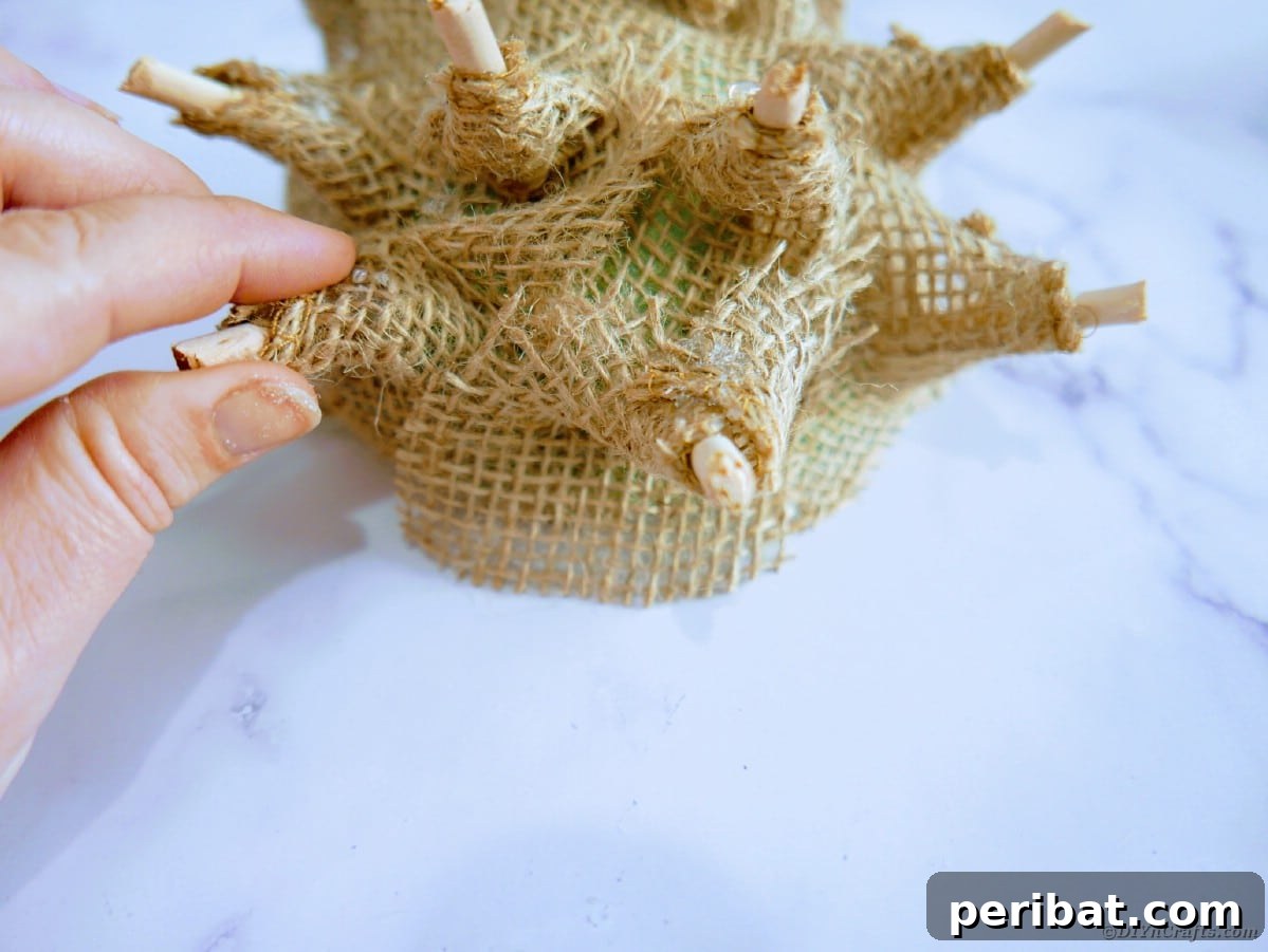 Create a Charming Burlap Hedgehog Decoration 17 Inserting burlap-covered wooden dowel spikes into the floral foam half ball