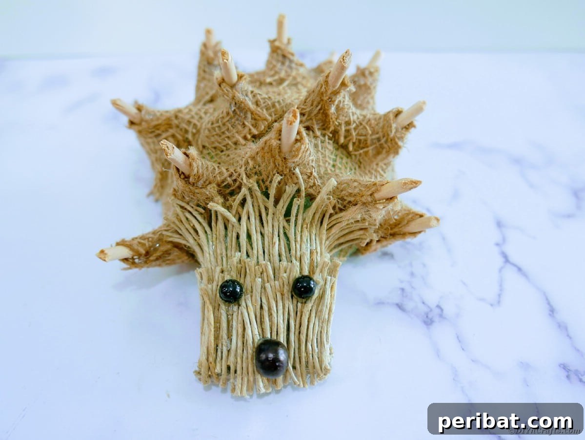 Create a Charming Burlap Hedgehog Decoration 19 Final step of hot gluing the hedgehog face onto the burlap-covered body