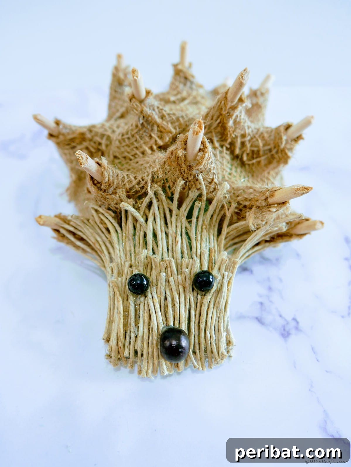 Create a Charming Burlap Hedgehog Decoration 21 Burlap hedgehog decoration displayed on a table with other rustic elements