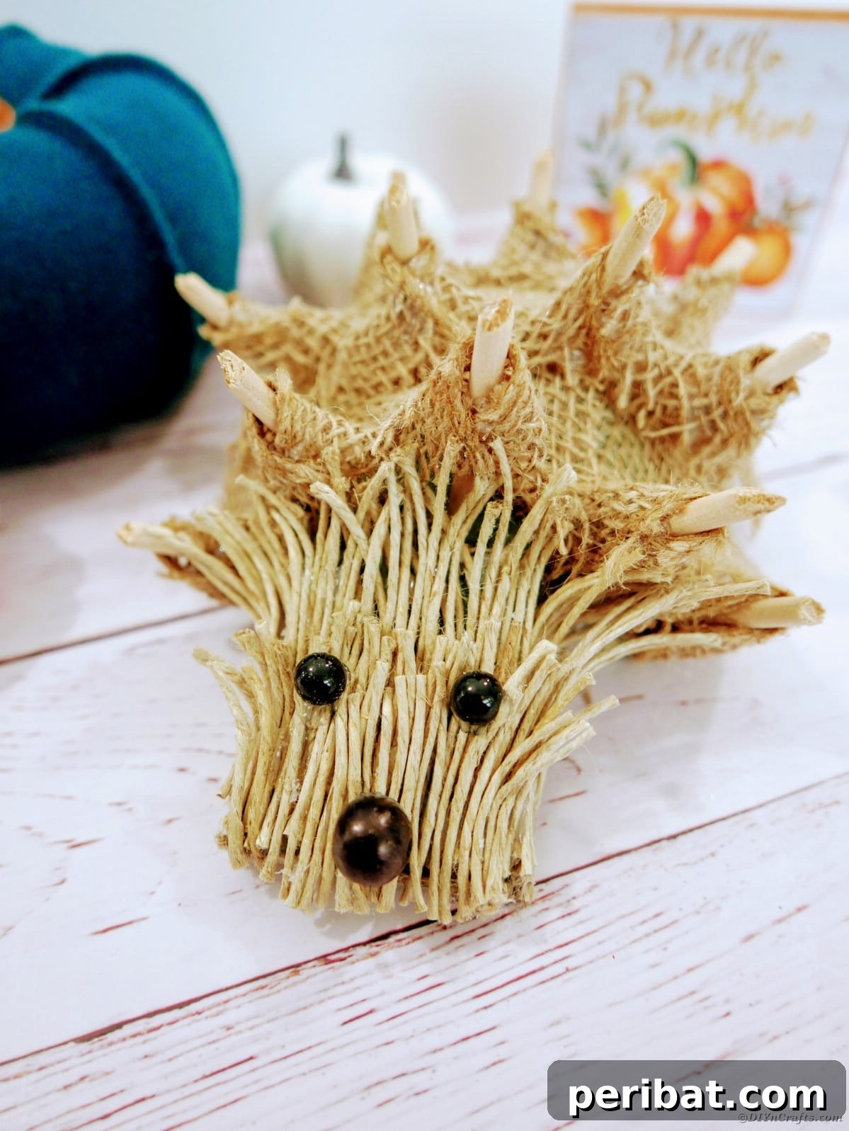 Create a Charming Burlap Hedgehog Decoration 22 Various burlap hedgehogs arranged together on a wooden surface, showcasing their handmade charm