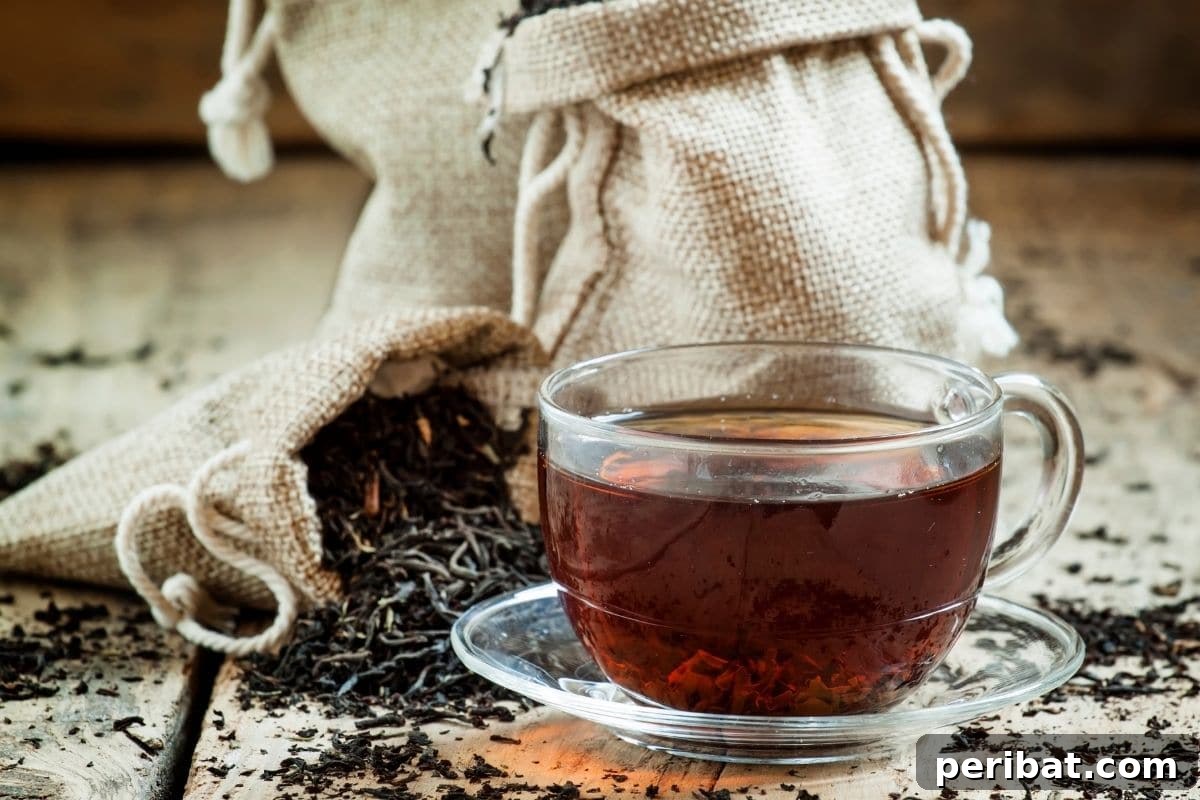 13 Clever Tea Bag Uses for a Healthier Garden 13 Dried black tea leaves spread on a surface, highlighting their natural properties.