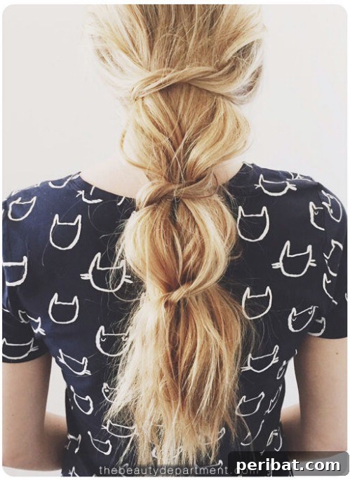 Embrace the ultimate boho-hippie-beachy vibe with a messy knotted ponytail, using your own hair
