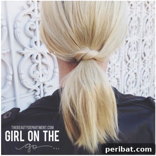 An elegant small-knotted ponytail, a fresh alternative to wrapping hair around the elastic