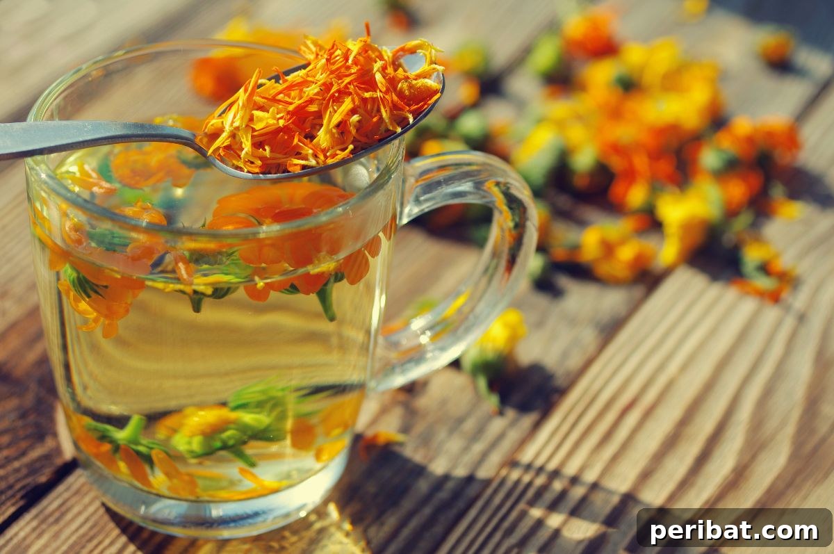 marigold flower made into a tea in the wooden table with clear glass