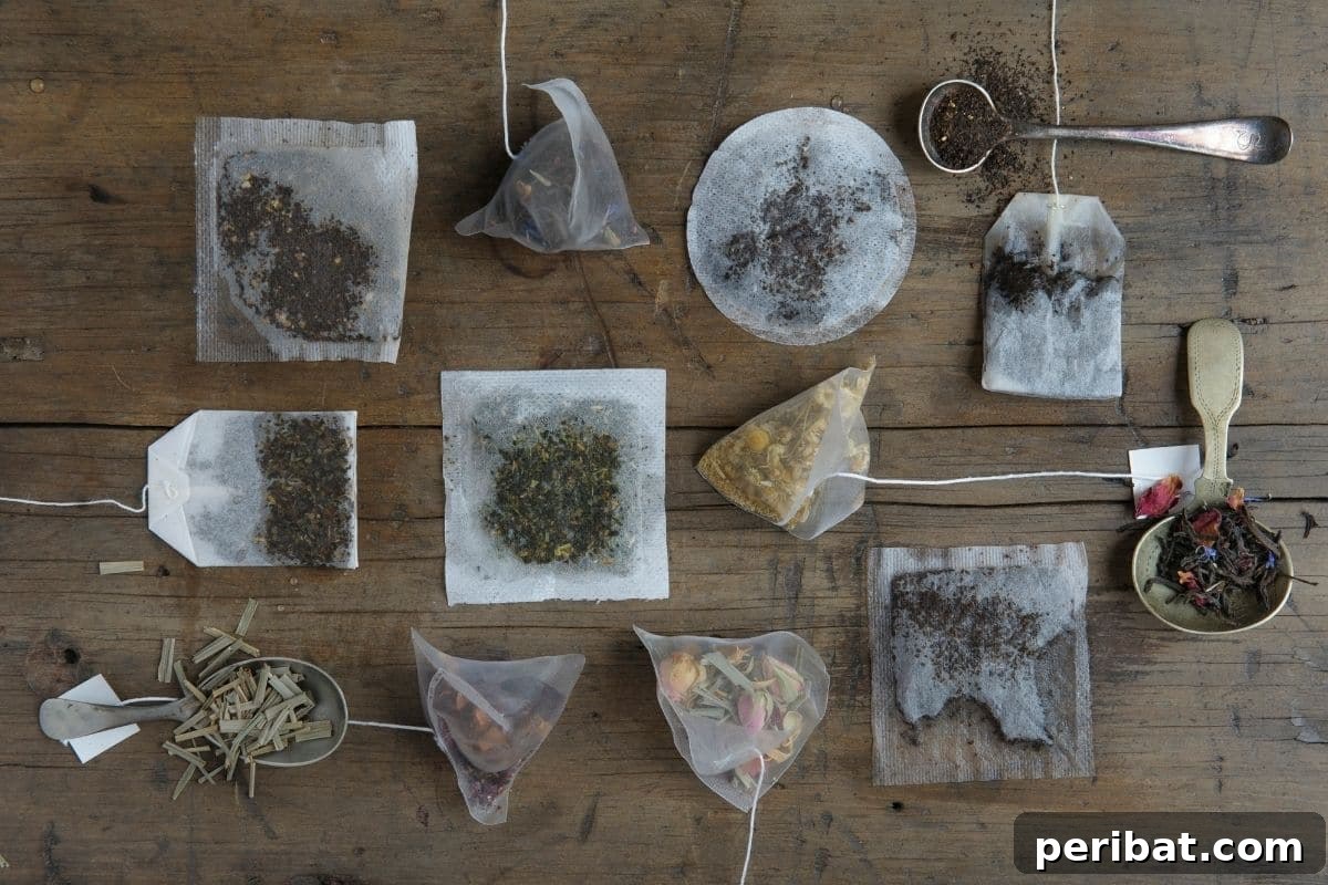 Variety of used or consumed tea bags laid out on a table, ready for repurposing as fertilizer