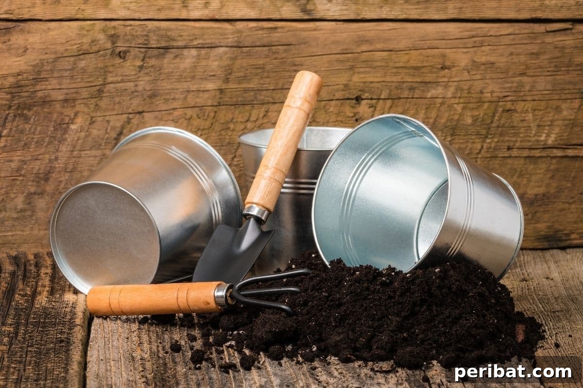 Potting soil spilled on a wooden table with small bucket and gardening tools