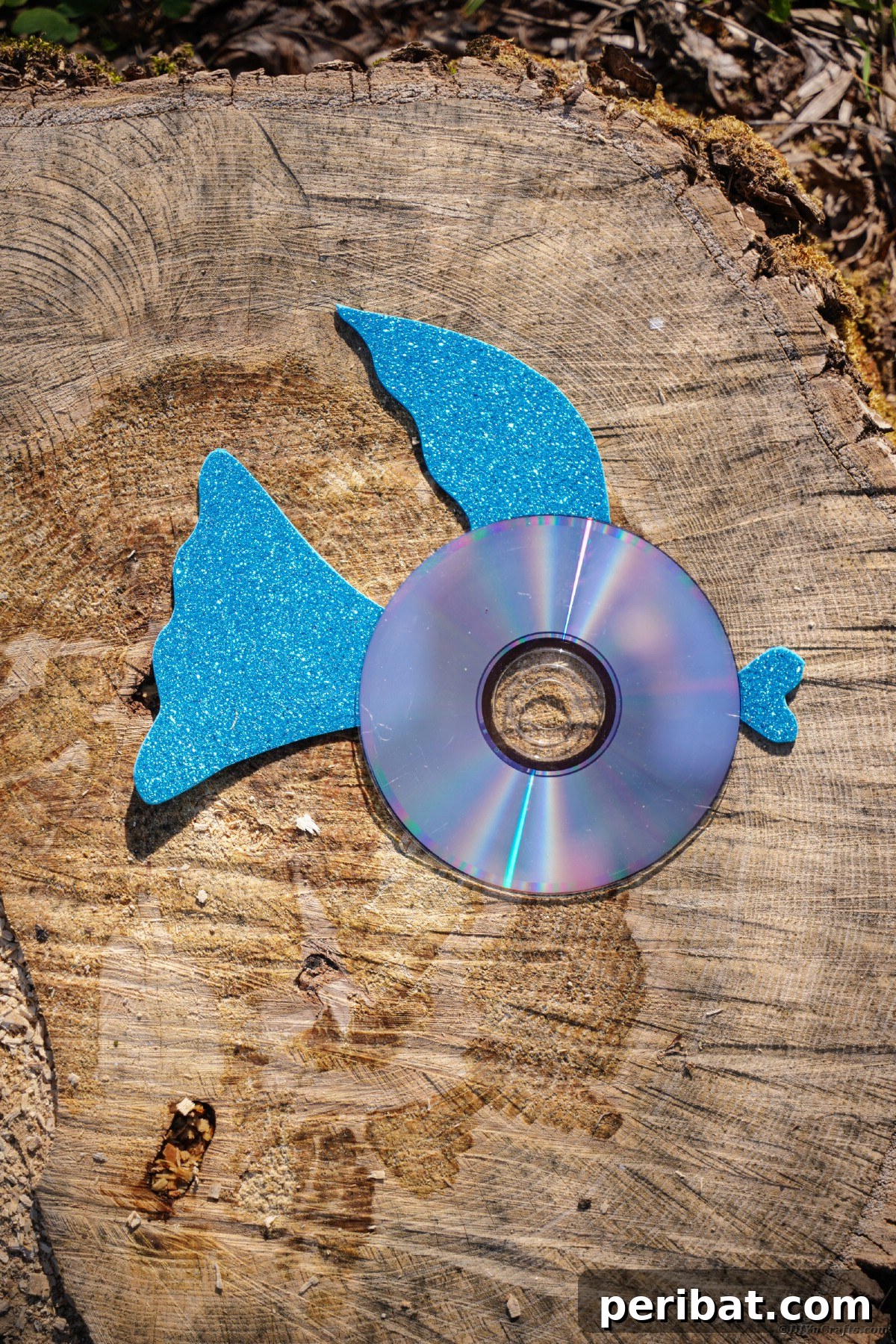 Crafting Whimsical Fish and Bird Decor from Old CDs 22 Blue fin CD fish on wood slice