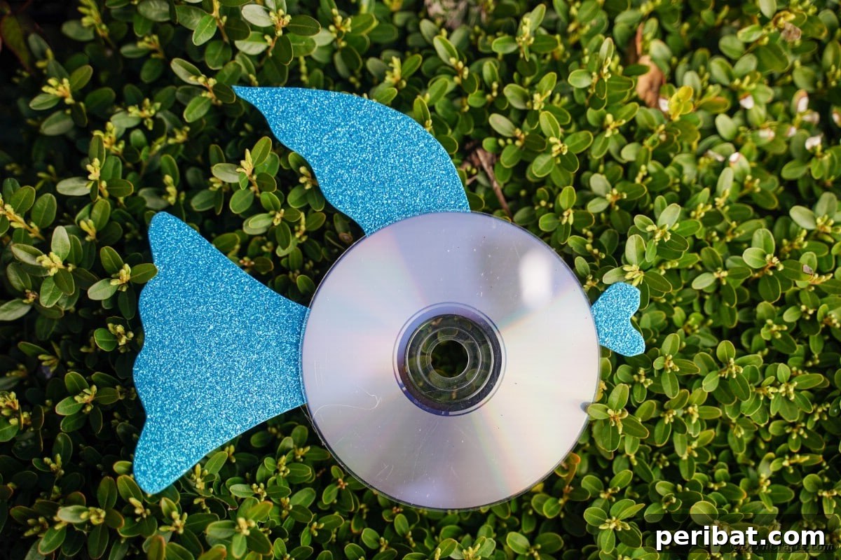 Crafting Whimsical Fish and Bird Decor from Old CDs 7 Blue CD fish on grass