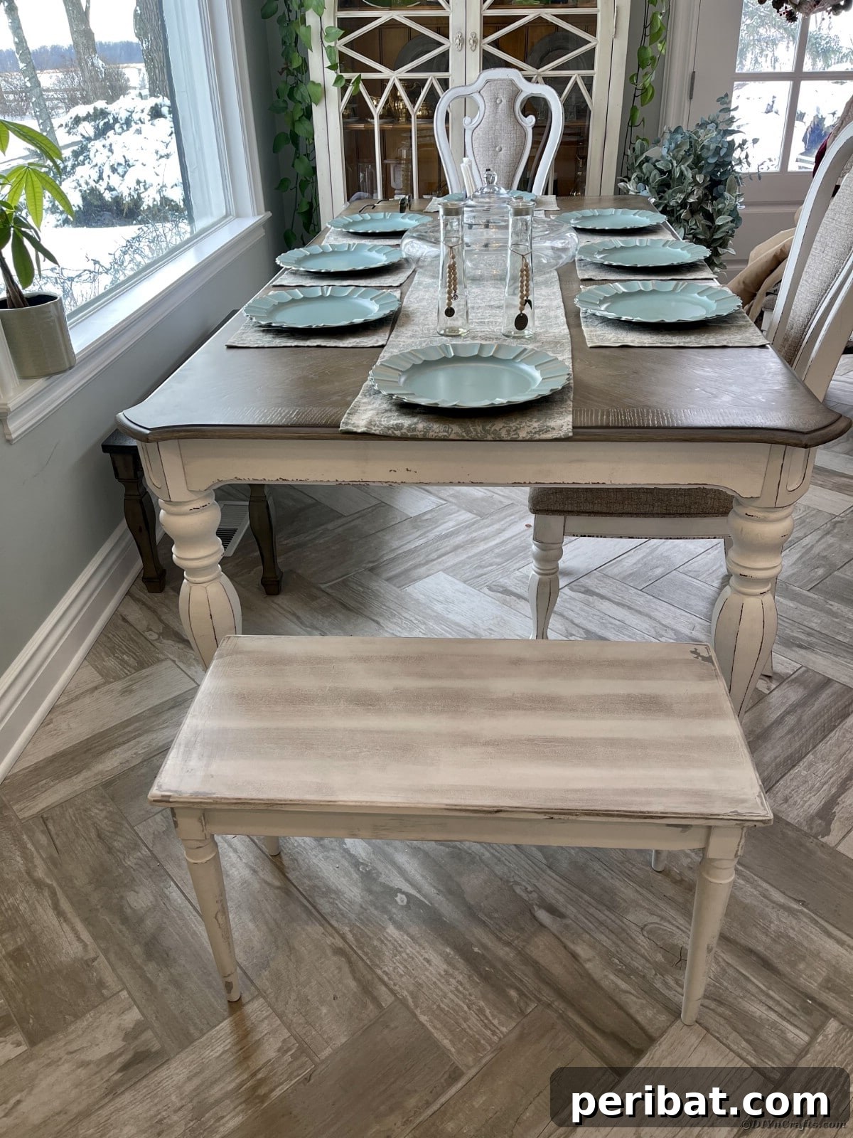 A close-up view of the finished distressed dining table and bench, highlighting texture and color