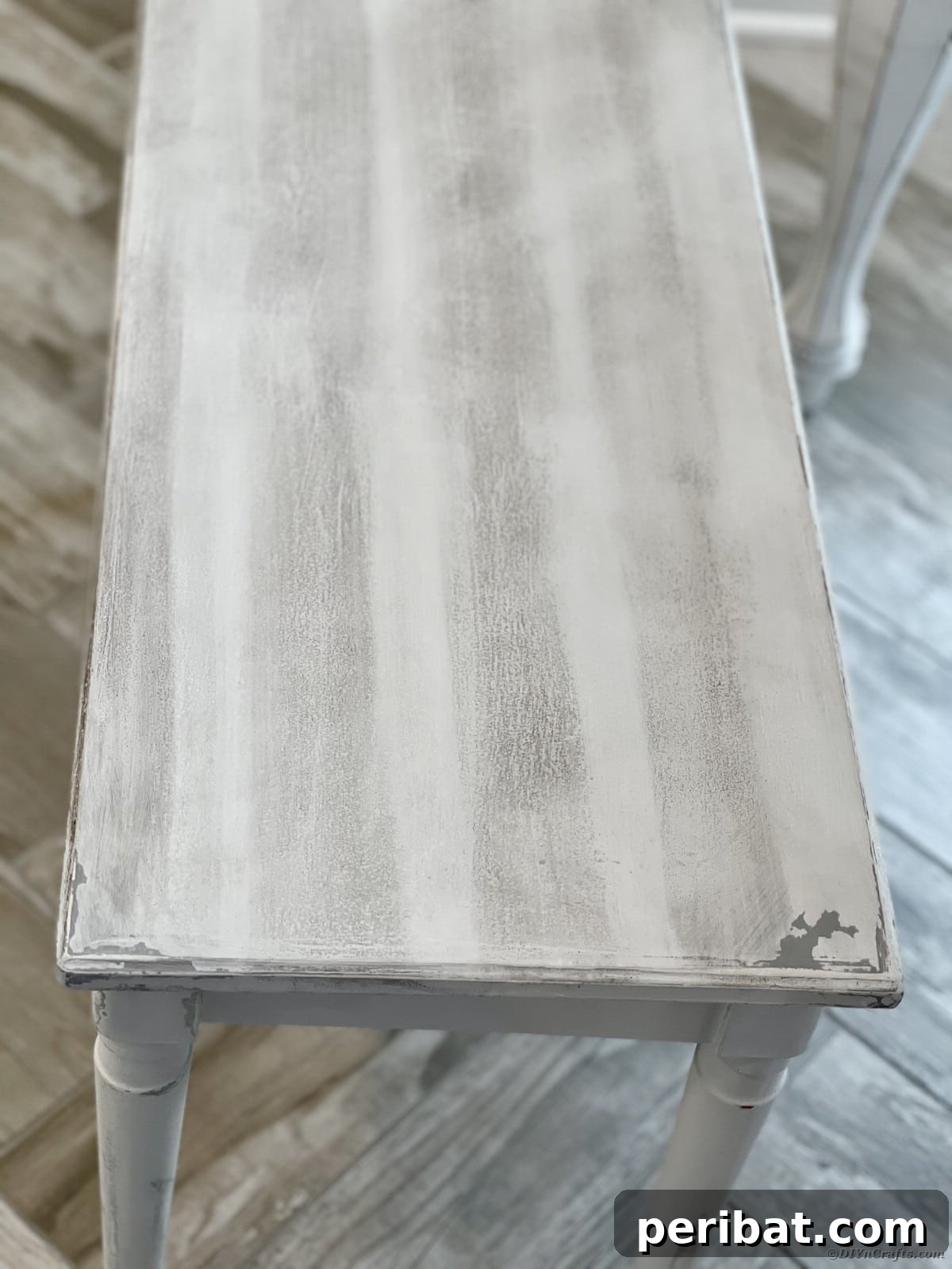 A beautifully distressed wooden bench with a subtly worn finish