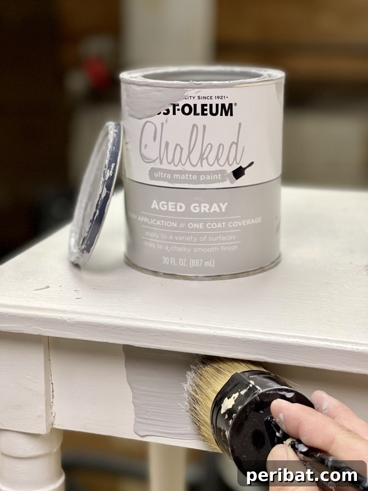 Applying Rust-Oleum Aged Gray Chalked Paint to a wooden bench with a natural bristle brush