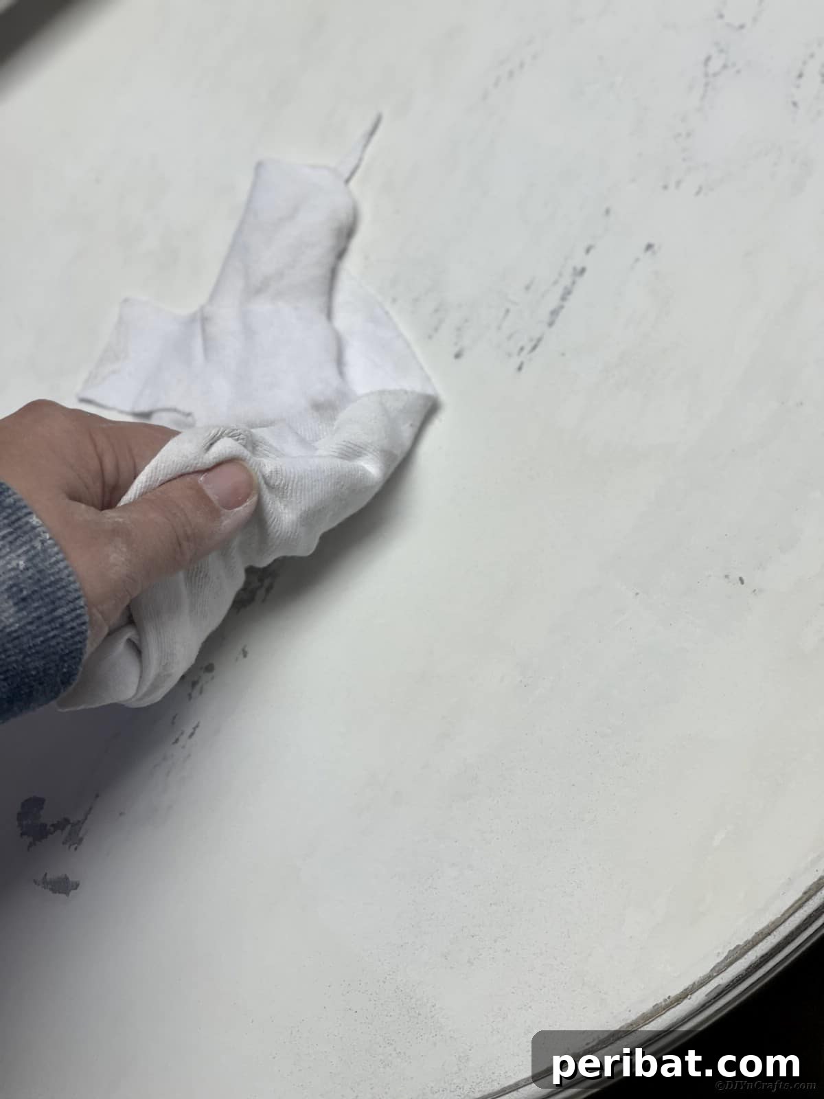 Chippy Charm Side Table Transformation 14 White cloth being wiped over top of white table