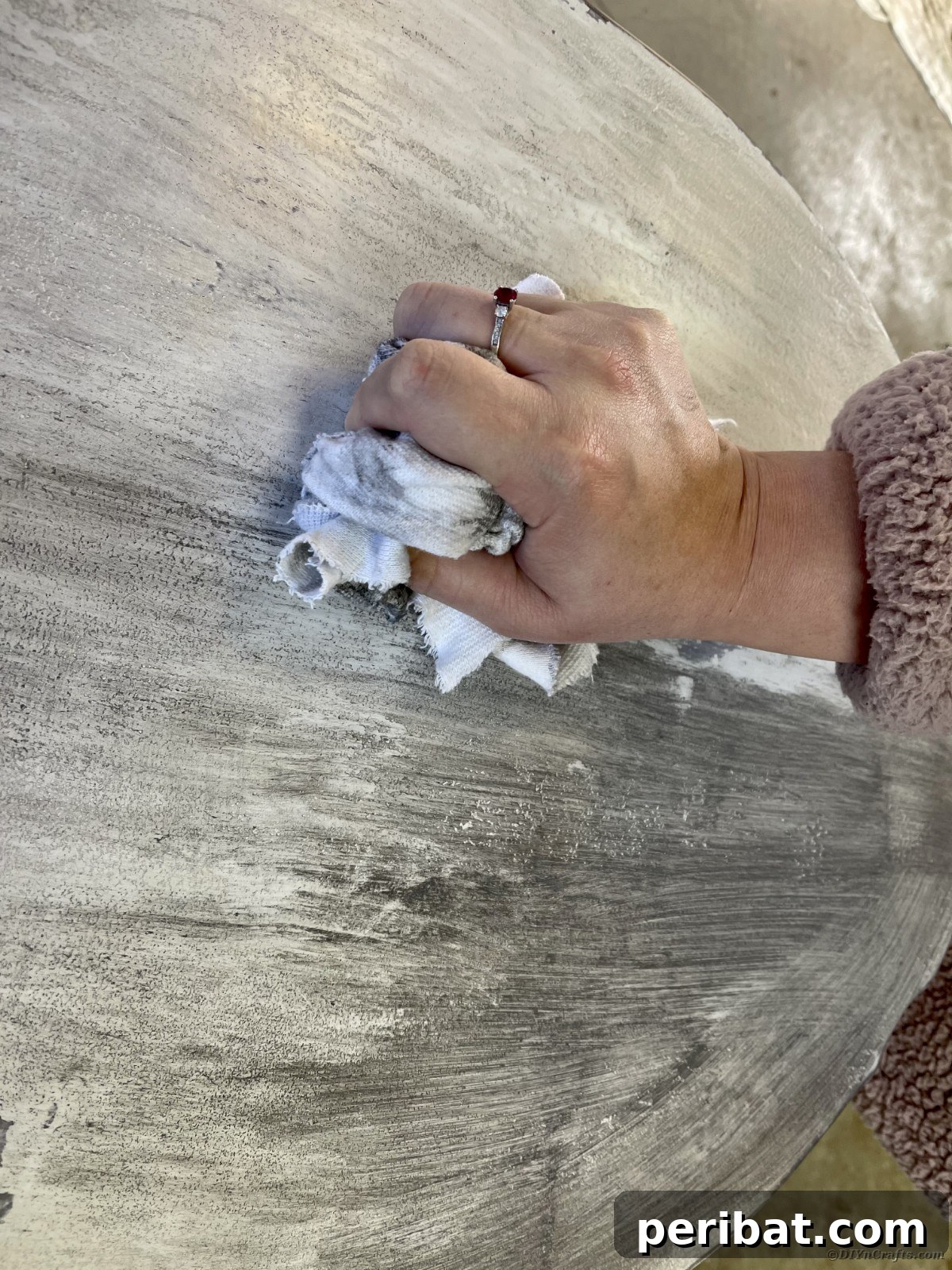Chippy Charm Side Table Transformation 16 Hand wiping wax off top of gray table