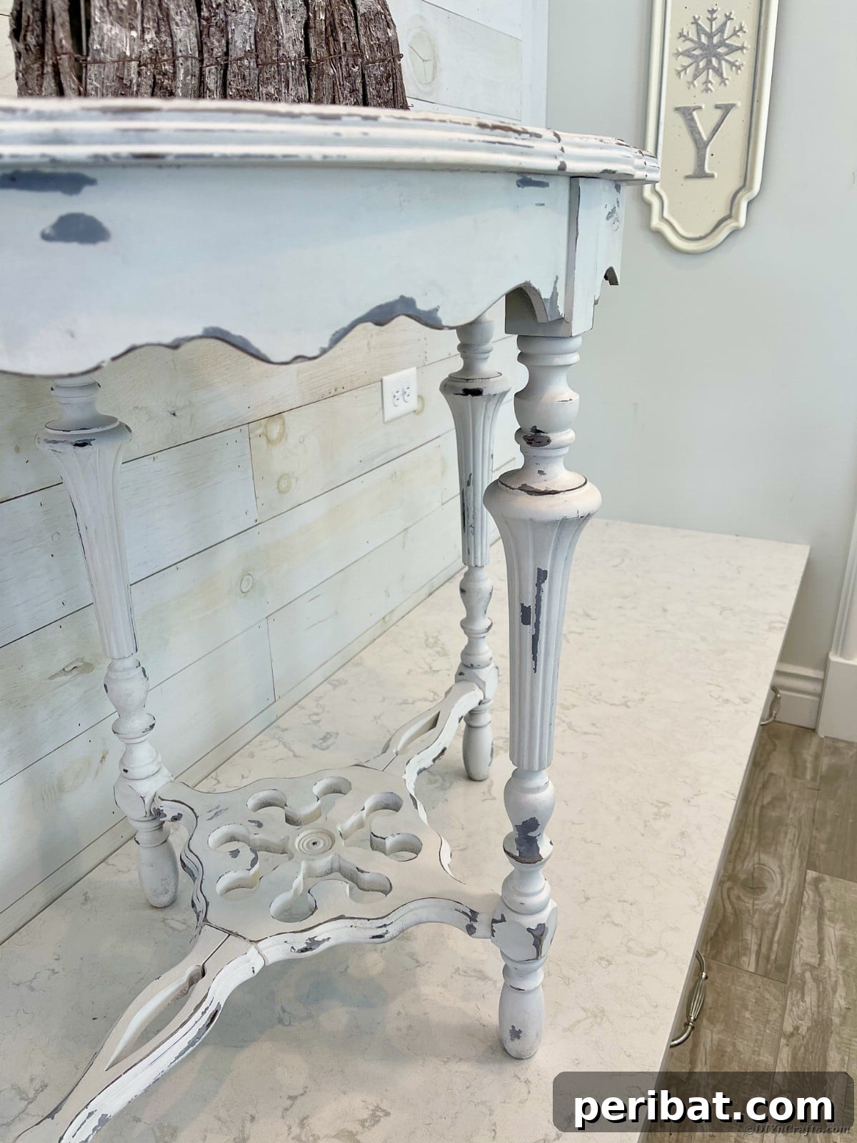Chippy Charm Side Table Transformation 5 Finished distressed side table on white table with white brick wall