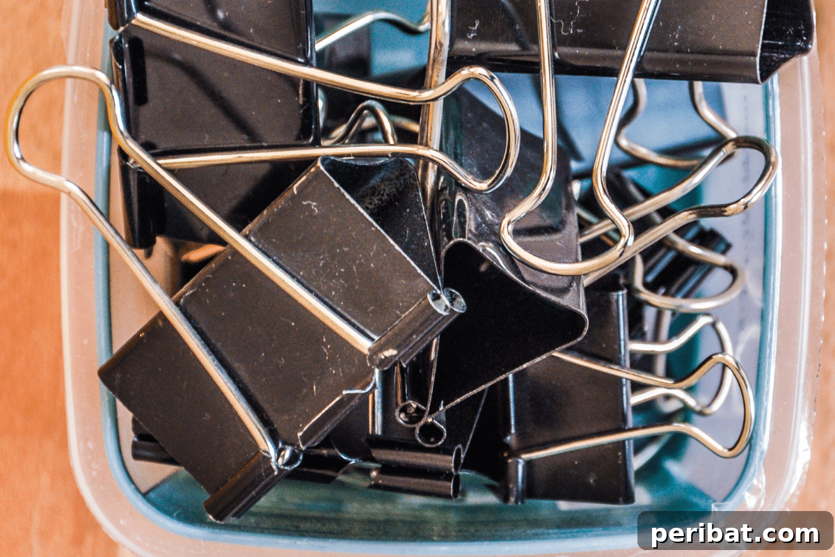 Upcycled Garden Cloches: Clever Ways to Shield Your Plants 11 binder clips in a Tupperware